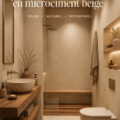 Salle de bain moderne avec finition en microciment beige et décoration élégante.